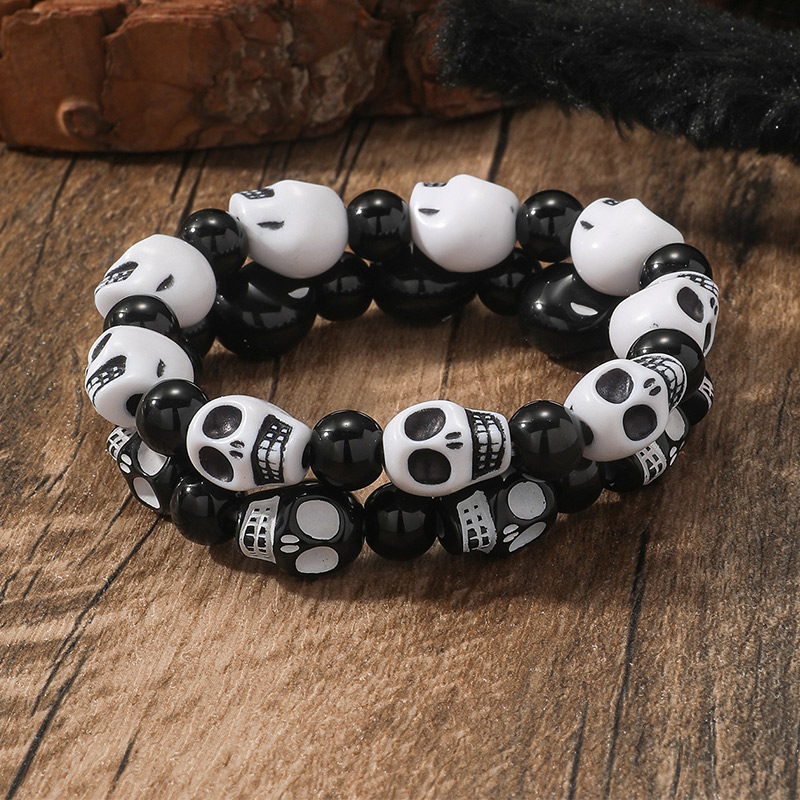 1745633304910106624 2pcs White & Black Smiling Skull Head Stretch Bracelets Set - Image 1
